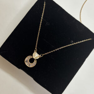 Full view of dainty gold heart pendant necklace on white background