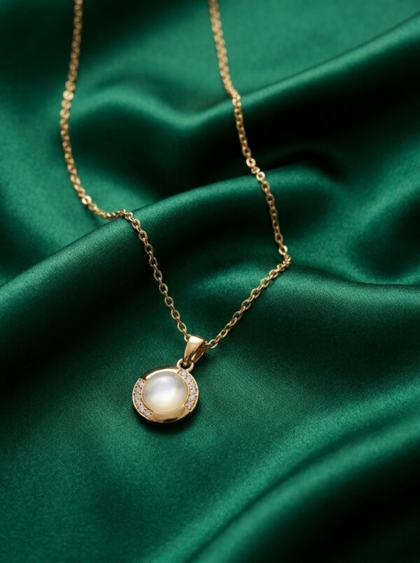 Lumina gold plated necklace with pearl pendant on black velvet