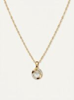 Lumina gold plated necklace with pearl pendant on black velvet