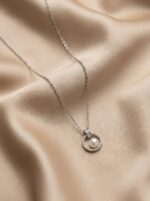 Silver pearl pendant necklace on white background