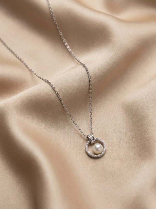 Silver pearl pendant necklace on white background