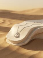 Silver pearl pendant necklace on white background