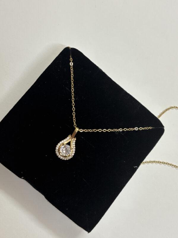 Front view of elegant gold plated pendant necklace with sparkling stone