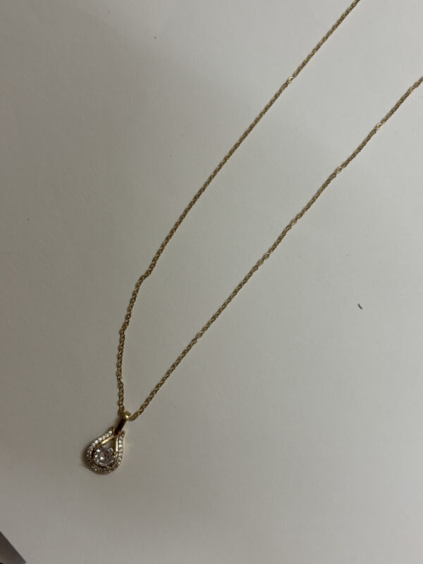 Lumina Gold Plated Pendant Necklace on a desert-inspired stone display