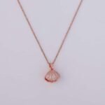 A close-up of the Pearl Shell Pendant Necklace on a black velvet box