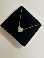 Full view of heart necklace on white surface
