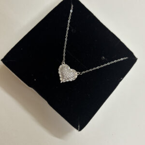 Full view of heart necklace on white surface
