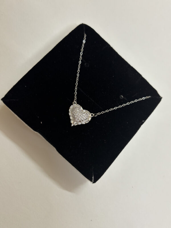 Full view of heart necklace on white surface