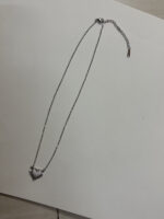 Model wearing silver heart necklace
