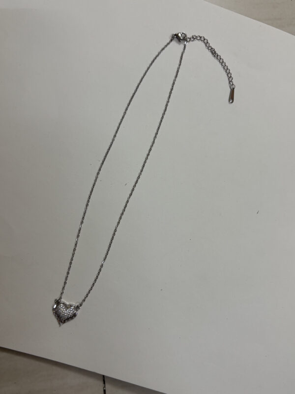 Model wearing silver heart necklace