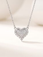 Close up of silver heart necklace on black velvet box