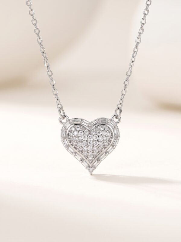 Close up of silver heart necklace on black velvet box