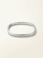 The Serene Silver Kada elegantly placed on a soft stone surface