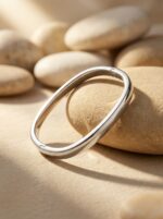A woman wearing the minimalist Silver Kada while reading