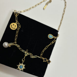 Close up of the charms on the gold plated necklace