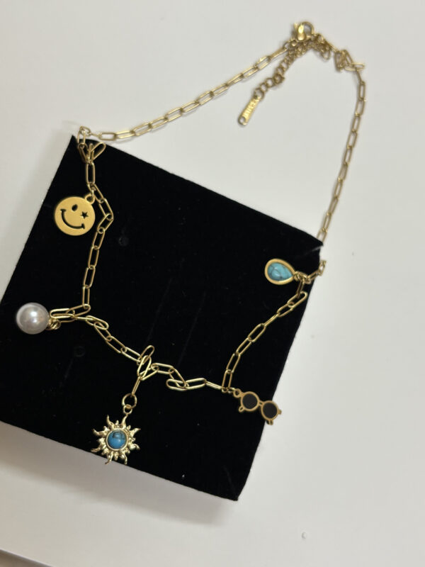 Close up of the charms on the gold plated necklace