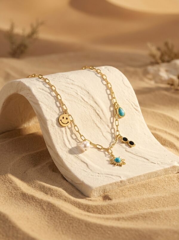 A gold plated necklace with various charms displayed on a black velvet stand