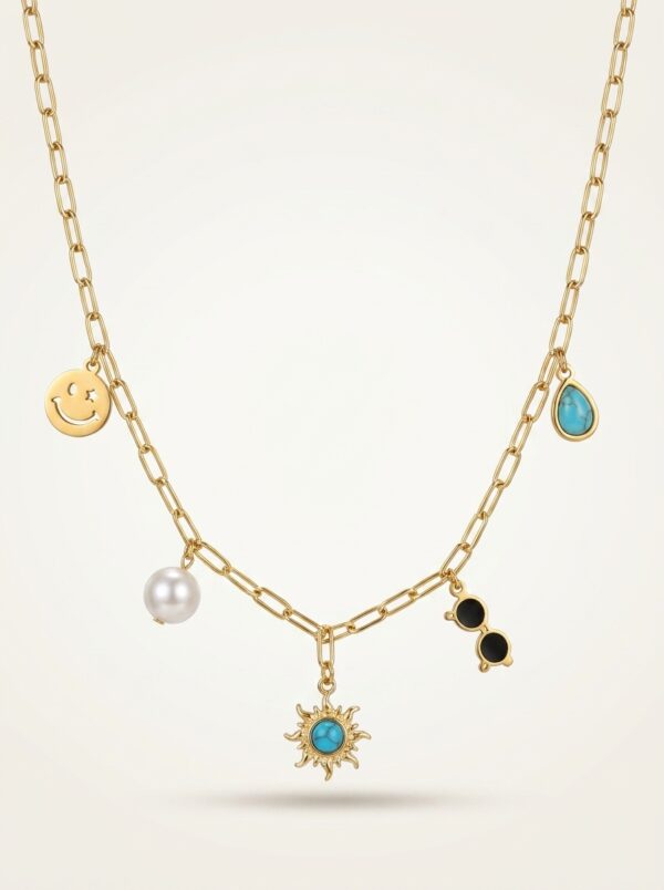 A gold plated necklace with various charms displayed on a black velvet stand