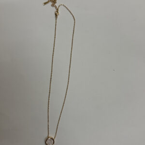 Close up of the round pendant with pave details on a velvet stand