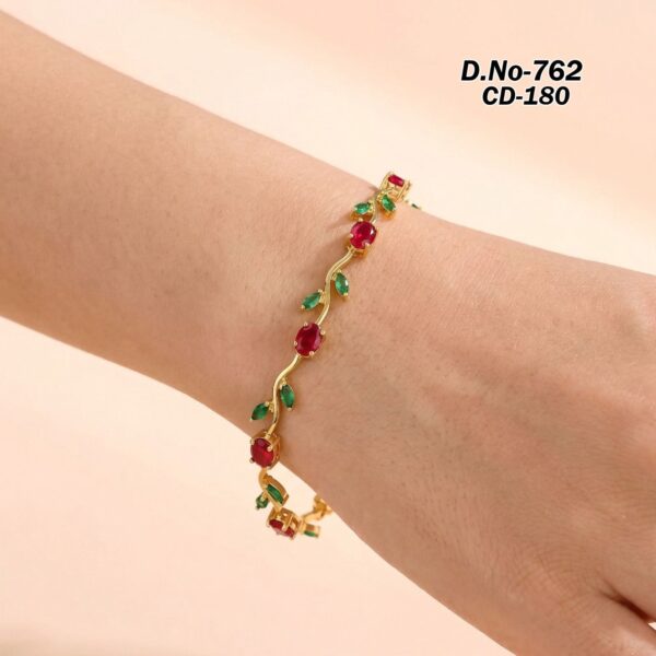 Close up of the gold plated ruby bracelet with green leaves