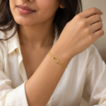 A woman wearing a delicate gold plated bracelet on her wrist