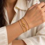 Elegant double-strand gold plated bracelet featuring a centered knot design