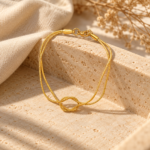 Elegant double-strand gold plated bracelet featuring a centered knot design