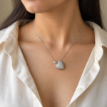 Woman wearing silver-tone heart necklace