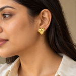 Model wearing gold plated heart stud earrings