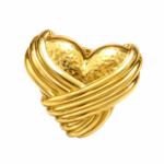Close up of gold heart earrings on white background