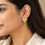 Model wearing elegant gold heart earrings