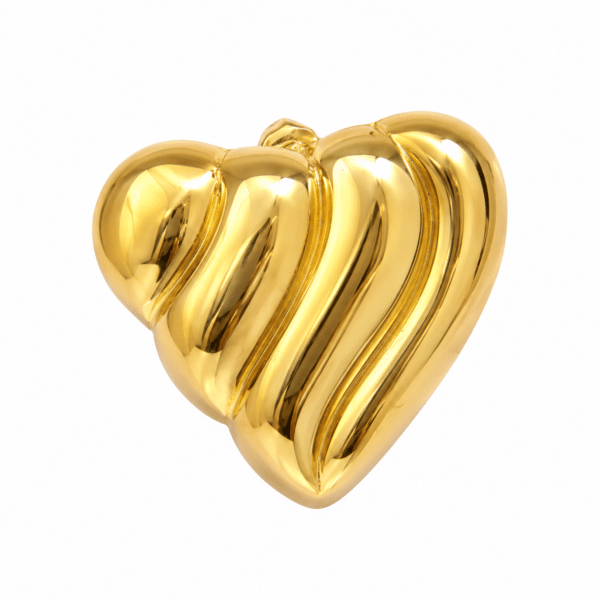 Close up of a single gold heart earring