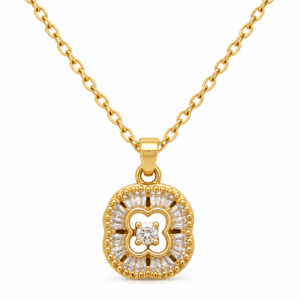 Close up of gold plated necklace with clover charm and baguette stones