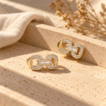Close up macro of gold plated earrings with crystal baguette accents