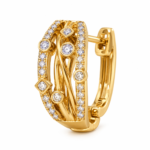 A detailed side view of a single gold-plated hoop earring with intricate stone-studded design