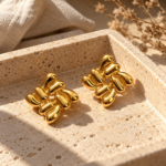 Pair of liquid gold Aura Gold Stud Earrings on white background