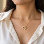 Close up of the Aura Heart gold plated heart necklace on model