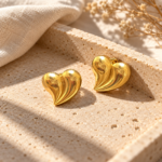 A pair of gold plated heart earrings featuring a smooth, sculptural design