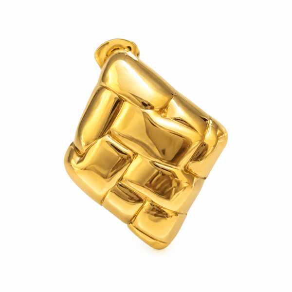 Close up of a single gold plated stud earring with intricate woven texture