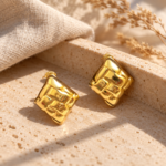A pair of gold plated stud earrings featuring a geometric woven texture