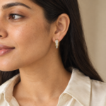 A woman wearing elegant gold plated huggie hoops