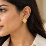 Model wearing gold Textured Gold Studs earring with a cream shirt