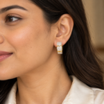 Woman wearing gold hoop earrings with pavé detailing