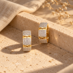 Two gold plated hoop earrings with pavé stones side by side