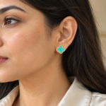 Model wearing turquoise clover gold plated earrings