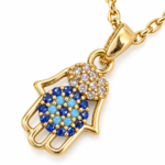 Close up detail of Hamsa pendant with blue and white stones