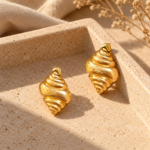 Pair of Conch Shell Golden Earrings against a white background
