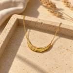 Close up of gold plated crescent moon necklace