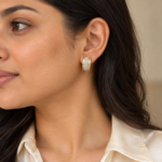 Woman wearing delicate gold Lumina Crystal Hoop Earrings