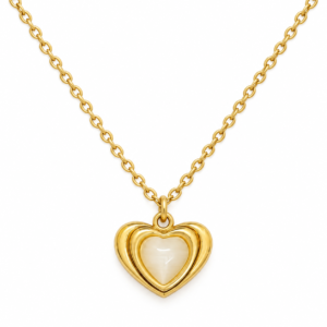 A delicate gold chain featuring a sculptural heart pendant with a glowing mother of pearl center